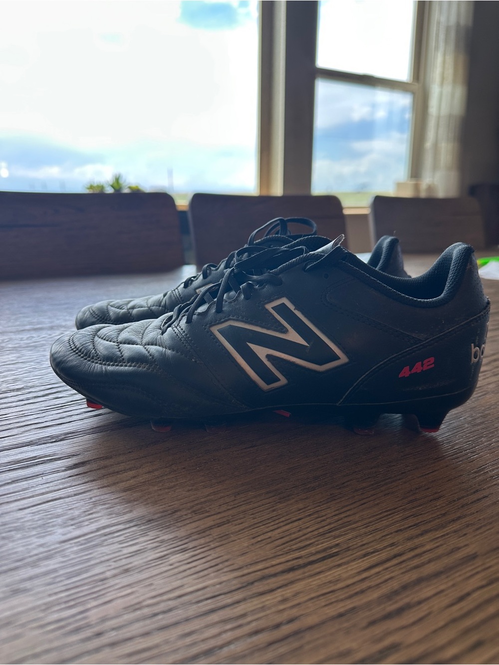 New Balance Black Soccer Cleats with Red Accents
